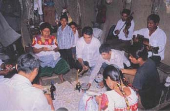 Photo 1. Nahua ritual specialists cut sacred paper images in preparation for the blood sacrifice and pilgrimage to Postectli.