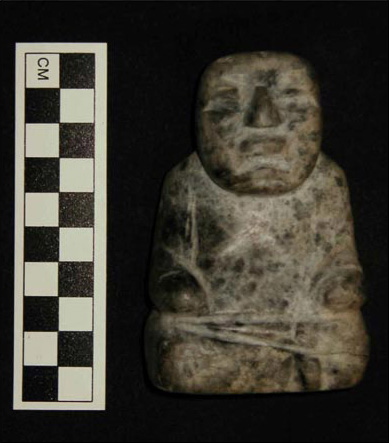 Figure 9. Greenstone seated figure recovered from a Conchas phase level of Suboperation 2k. Figure 9. Greenstone seated figure recovered from a Conchas phase level of Suboperation 2k.