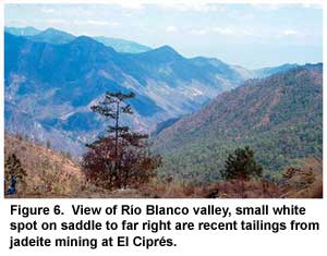 Figure 6. View of Río Blanco valley, small white spot on saddle to far right are recent tailings from jadeite mining at El Ciprés. Figure 6. View of Río Blanco valley, small white spot on saddle to far right are recent tailings from jadeite mining at El Ciprés.
