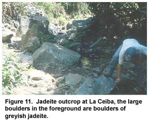 Figure 11. Jadeite outcrop at La Ceiba, the large boulders in the foreground are boulders of greyish jadeite. Figure 11. Jadeite outcrop at La Ceiba, the large boulders in the foreground are boulders of greyish jadeite.