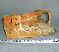Figure 34b. Potstand made from recycled flared-neck jar, showing discoloration due to reheating and baked-on clay, PVC 161.