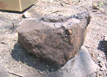 Figure 44c. Furnace from discarded furnace deposit showing exterior corner and slag on interior.