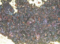 Figure 46b. Slag from copper smelting: crushed slag showing small copper prills.