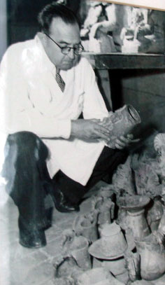 Figure 8. Photograph of Alfonso Caso with a pile of Zapotec urns, probably ca. 1950s.