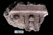 Figure 3:54 - This is an enframing element (top) underneath which are beads attached to an elongated form. This decorative arrangement is rather common in the fa&ccedil;ade collection. These beads are set within parallel rows delineated by incised lines of moderate depth.