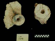 Figure 3:83 - These two perforated discs are from LA 1293. The large example on the right is red, but its front surface is painted white.