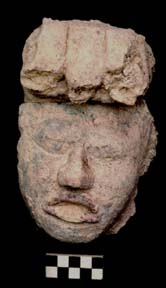 Figure 3:86 - This head, attached to a stone armature, may represent a lesser member of the elite royal court. On his head he wears a trefoil crown, similar but smaller to the example shown in Figure 3:96.