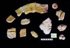 Figure 3:98 - These fragments, recovered in LA 1289, are mostly painted yellow and represents a curvilinear band with a black stripe that terminates at a human head. Several other pieces associated with this band, have not been intensively analyzed or compared for joining.
