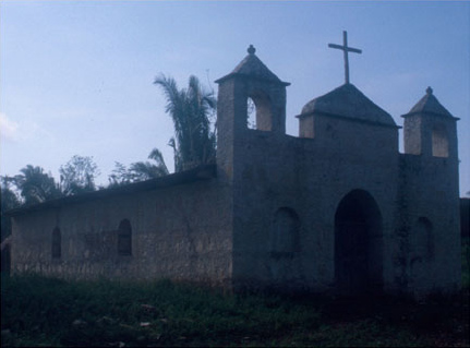 Figure 11. The recently completed church in modern La Caoba, built in part from fill material taken from remains of ancient Maya structures. Figure 11. The recently completed church in modern La Caoba, built in part from fill material taken from remains of ancient Maya structures.